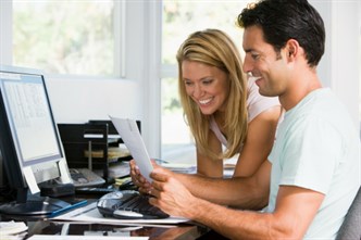 Man -and -women -reading -a -letter -by -the -computer -at -home _SK3ulh RBs SMALL